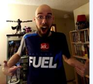 arm bald balding beard book bookshelf clothes dallas_fuel ear excited figurine fingernail glasses hat helmet irl jack_in_the_box lamp logo looking_at_you open_mouth overwatch pointing shelf soyjak teeth text tongue tshirt variant:shirtjak video_game white_skin // 618x559 // 452.6KB